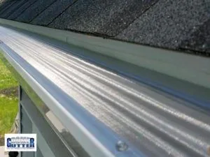 GutterDome GD45 Adjustable gutter guard installed on a comp shingle roof at a dormer